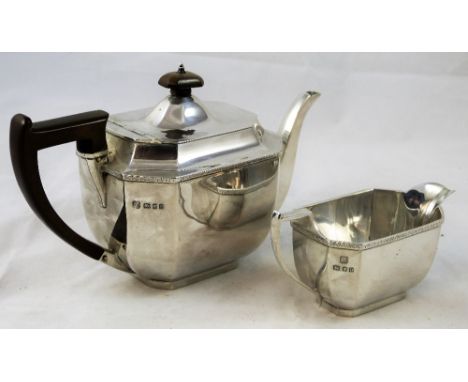 An Art Deco silver tea pot and milk jug, Birmingham 1930, of octagonal panel form with brown resin handle and finial, height 