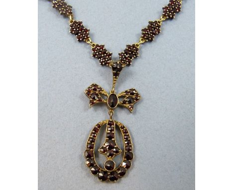 An early 20th century silver gilt and Bohemian garnet necklace, claw set with faceted stones, later 9ct gold back chain.
