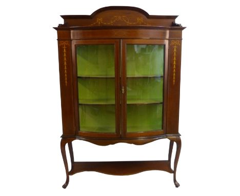 An Edwardian mahogany display cabinet with classical style inlay of swags, husks and ribbons, comprising arched raised back o