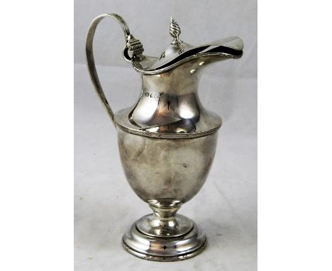 A silver claret jug, Birmingham 1913, of urn form raised on a pedestal foot, flame finial, height 17 cm, weight 8.5 oz.