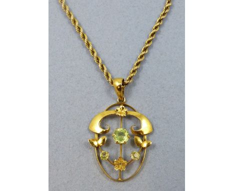A Victorian 9ct gold and green paste pendant, of scroll form, to a 9ct gold rope twist chain, weight 12 gm.
