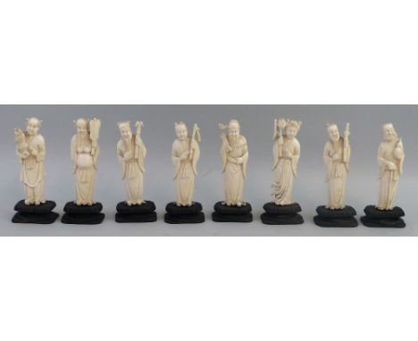 An early 20th century set of eight Chinese carved ivory figurines, depicting the Eight Immortals, each mounted on an ebonised