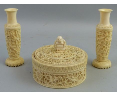 A Cantonese ivory box and cover, of circular form, the sides and slightly domed lift off cover carved with dragons and scroll