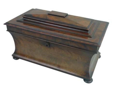 An early 19th century mahogany tea caddy, of oblong form, the hinged lid with a stepped top and moulded edge, on a concave ba