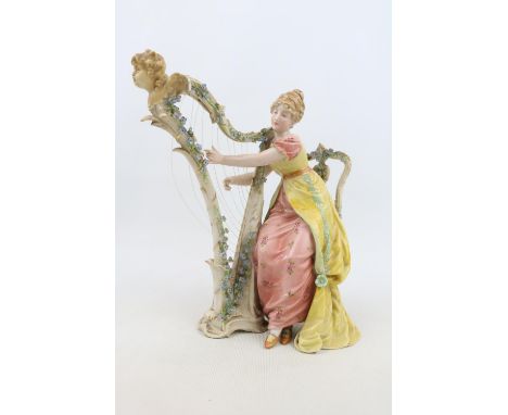 European Bisque porcelain figure of a woman playing a Harp with scrolled mark to base and Arrow blue mark. 23cm in Height 