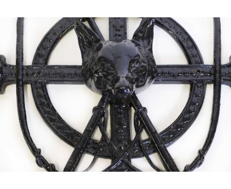 A cast iron whip rackwith a fox head before a pair of crossed crops56cm wide72cm highCondition ReportOne section has been bro