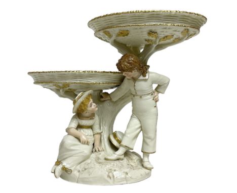 Royal Worcester figural double comport in the style of Kate Greenaway, modelled with a young boy and girl with painted featur