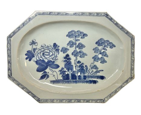 Late 18th century Delftware dish of elongated octagonal form, painted in blue with a large chrysanthemum bloom and trees with
