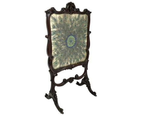 Late 19th century mahogany fire screen, the carved cresting rail with a central cartouche flanked by trailing scrolls surroun