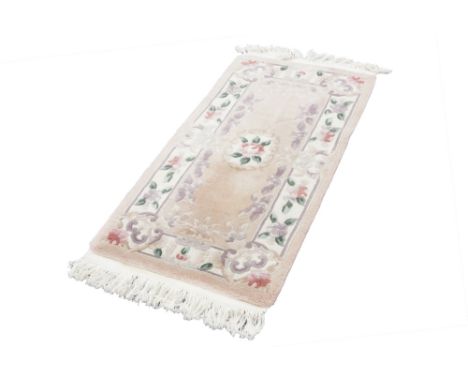 WASHED CHINESE 'KAYARN' SUPER QUALITY, ALL WOOL, EMBOSSED RUG, with three floral motifs on a pink field, off white and foliat