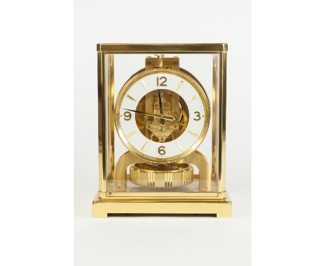 JAEGAR-LE-COULTRE GILT BRASS CASED ATMOS MANTLE CLOCK, the white chapter ring with raised Arabic and baton markers, housed in
