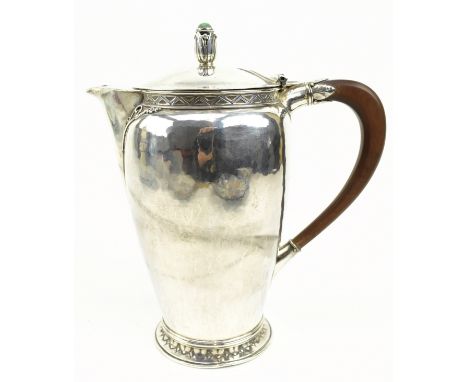 A George V hallmarked silver coffee pot / water jug. The silver jug being decorated with a bud shaped final with cabochon on 