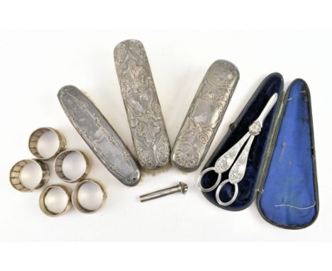 A collection of various hallmarked silver to include dressing table brushes, collection of napkin rings and a miniature hallm