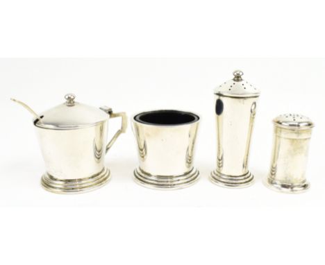 A set of four 20th century hallmarked silver cruet set. The lot comprising a pepperette, a mustard pot and a salt cellar 1962