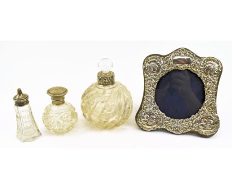 A 20th century hallmarked silver photo frame and silver mounted cut glasses perfume bottles. The lot to include a hallmarked 