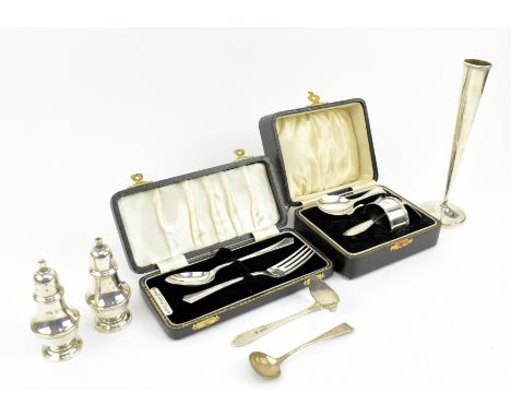 Two cased of hallmarked silver Christening gift sets. The lot to include a George V cased set of a spoon, a pusher and a napk