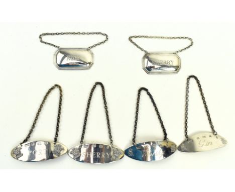 A collection of six hallmarked silver bottle tag / wine labels. The lot to include a whisky tag and a gin tag. Hallmarked yea