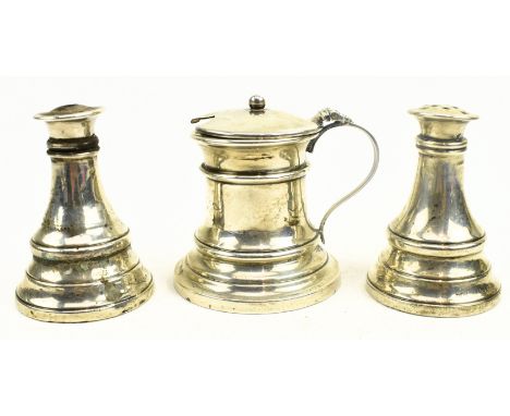 A George V three-piece blue glass lined hallmarked silver condiment set. The lot to include a blue glass lined mustard pot, a