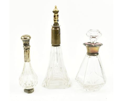 A collection of five silver collared perfume bottles. The lot to including a faceted cut glass bottle with a silver and pink 