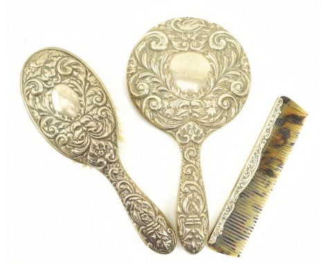A 20th century hallmarked silver dressing table / vanity set. The lot to include a mirror and a brush. Hallmarked year 1966, 