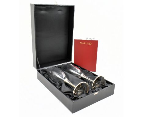 A cased pair of 21st silver mounted glass champagne flutes. Each glass body raised on silver stems to a spreading circular fo