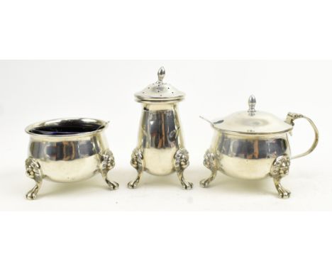 A 20th century three-piece silver hallmarked blue glass lined cruet set. The set to include a pepperette, a lidded mustard po