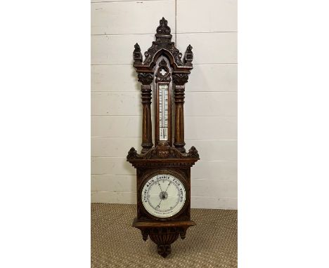 An oak cased barometer (H110cm W32cm)
