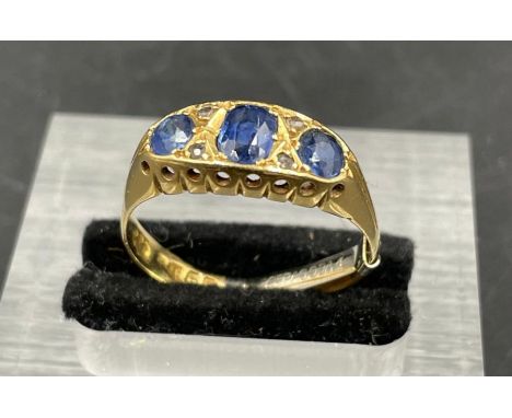 An 18ct gold three stone sapphire ring (Stones untested total weight 3.9g)