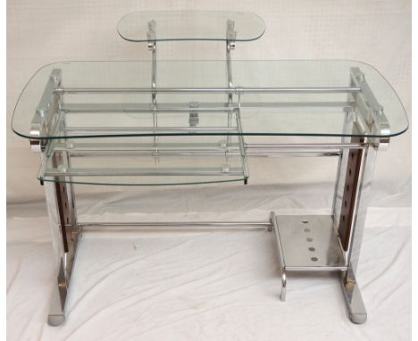 MODERN BRUSHED STEEL AND GLASS COMPUTER TABLE
with an upper kidney shaped glass shelf for a monitor above a full width glass 