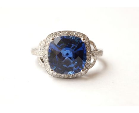 SAPPHIRE AND DIAMOND CLUSTER DRESS RING
the central checkerboard cushion cut sapphire approximately 5.45cts, in diamond surro