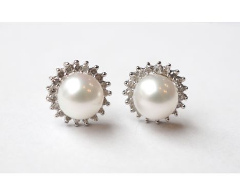 PAIR OF PEARL AND DIAMOND CLUSTER STUD EARRINGS
the central pearl on each in diamond surround, in nine carat white gold, the 