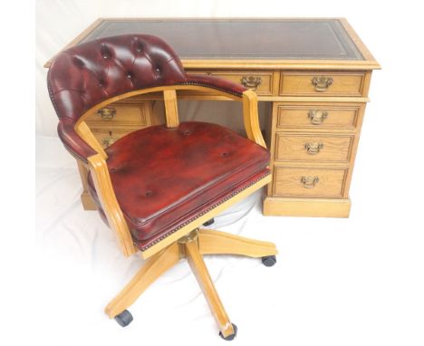 LIGHT OAK KNEEHOLE DESK
with an inset tooled leather top and an arrangement of nine drawers, 129cm wide, together with a matc