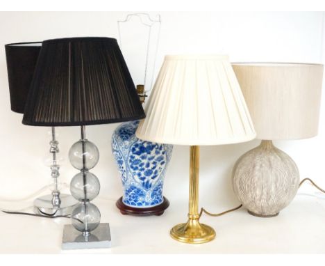 FIVE INDIVIDUAL LAMPS
comprising a pottery blue and white lamp with a white pleated shade, 61cm high, a brass column lamp wit