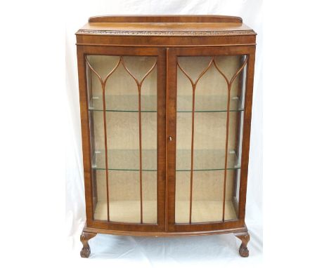 WALNUT BOW FRONT DISPLAY CABINET
with a shaped raised back above a pair of beaded glazed doors and glazed side panels, standi