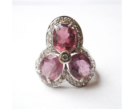 PINK TOURMALINE AND DIAMOND CLUSTER DRESS RING
the three oval cut tourmalines totalling approximately 6.5cts, in multi diamon