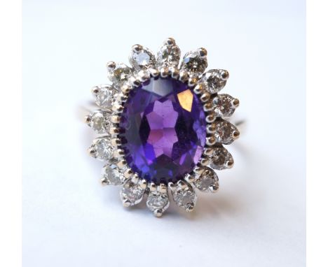 AMETHYST AND DIAMOND CLUSTER DRESS RING
the central oval cut amethyst approximately 3cts in sixteen diamond surround totallin