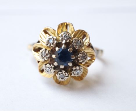 SAPPHIRE AND DIAMOND CLUSTER RING
the central sapphire and eight surrounding diamonds in flower head setting, in unmarked gol