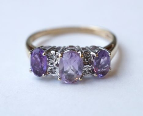 AMETHYST AND DIAMOND RING
the three oval cut graduated amethysts with small diamonds between, on nine carat gold shank, ring 