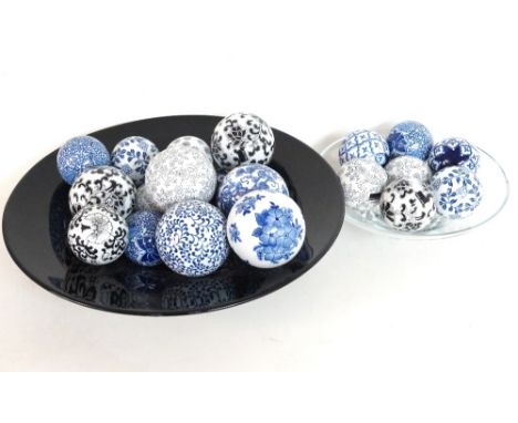 SELECTION OF DECORATIVE CERAMIC SPHERES
of varying sizes and patterns together with two glass bowls 