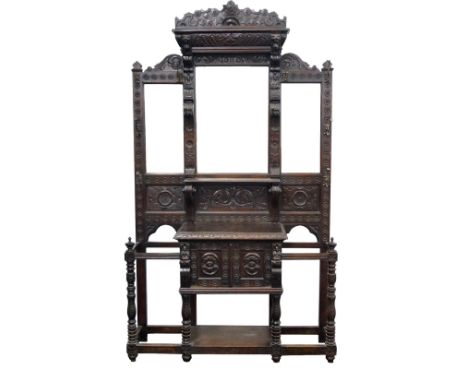 VICTORIAN CARVED OAK MIRROR-BACKED HALL STAND
with a shaped top above two lion masks with three bevelled plates below and an 