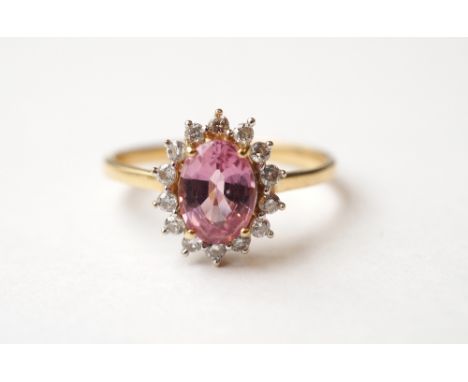 PINK SAPPHIRE AND DIAMOND CLUSTER RING
the oval cut sapphire approximately 1.2cts in fourteen diamond surround, on eighteen c