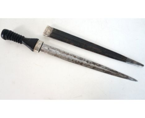 19th CENTURY SCOTTISH DIRK
with an engraved blade and carved bog oak handle in a black leather scabbard with engraved unmarke