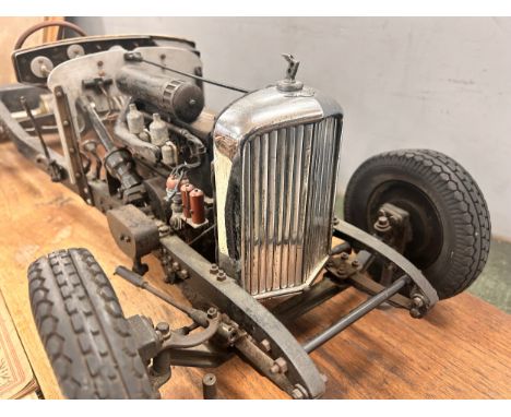 A Bentley mark V chassis with a wooden stand a part automobile engineer publication showing this model, some other related ep
