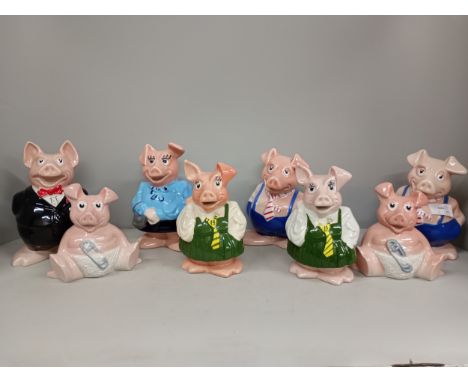 A collection of eight Wade NatWest pig money banks, one without stopper