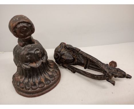 A cast Victorian door knocker together with a heavy cast door stop 