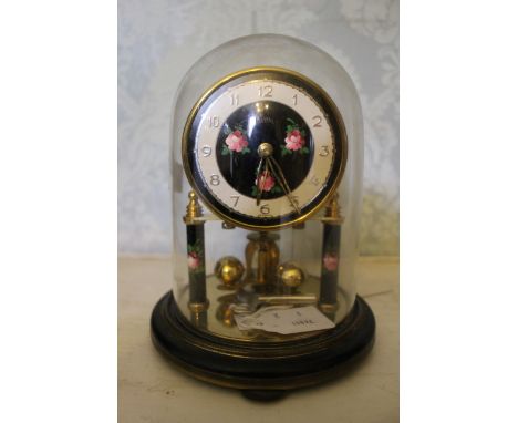 A Roma of Germany 400 day clock under glass dome, together with thermometer. Clock with 3" dial flowers to centre, matches na