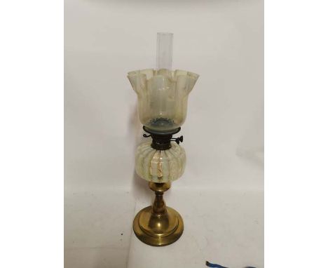 A brass based Victorian yellow vaseline glass oil lamp and shade, 64cm high. (1)