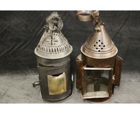 An early 19th century tin plate lantern with pierced domed top, horn panels, suspension loop, 33cm high and a similar lantern
