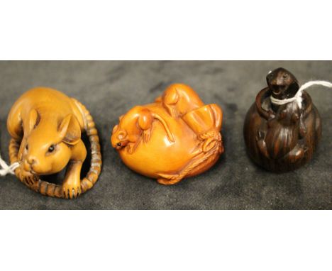 Three modern Japanese carved wood netsuke, one modelled as a rat with long tail, 5cm long, another as a snake in a jar attack