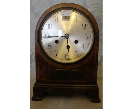 An Edwardian mantel clock with 2 train spring driven movement chiming on a gong contained in an oak case with a bur walnut pa